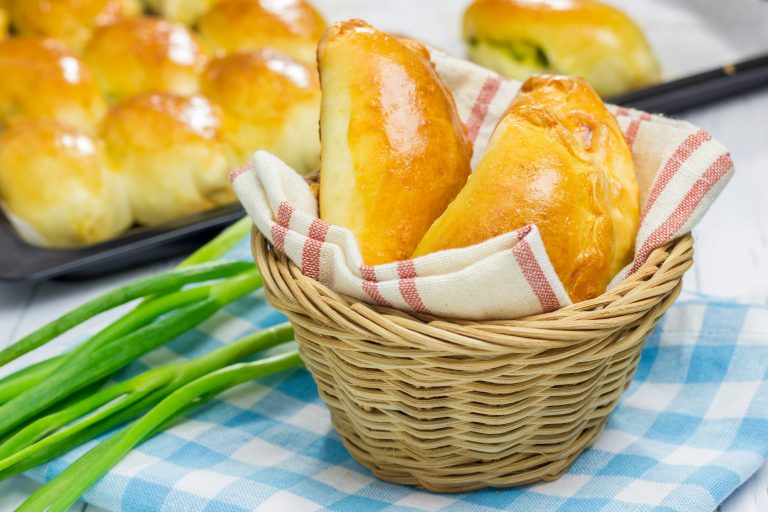 Russian pastries (pirogi) filled with eggs and green onion, closeup